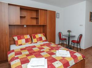 a bedroom with a bed and a table with chairs at Golden Coast Villa Caska in Novalja +166 photos