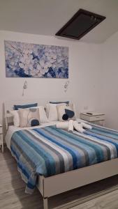 a bedroom with a large bed with a painting on the wall at Sa domu rubia in Iglesias
