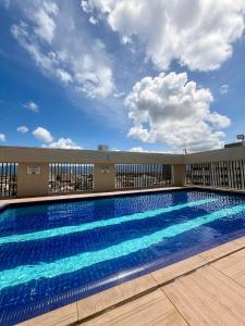 a swimming pool on the side of a building at Flat Romance Praia e Home Office in São Vicente