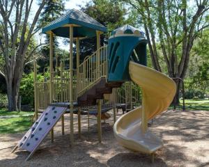 a playground with a slide and a play structure at El Capitan Canyon in Capitan