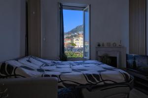 a bedroom with a bed and a window with a view at Nissa la bella in Nice