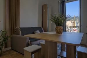 a living room with a table and a couch at Nissa la bella in Nice