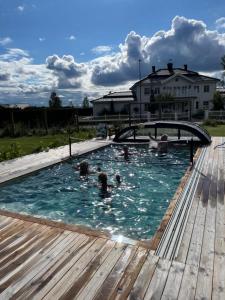 a group of people swimming in a swimming pool at Villa Golfgatan 32 Vintrosa Lanna in Vintrosa