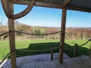 a hammock in a pergola with a view of a field at Golden Fleece in Macclesfield +7 photos
