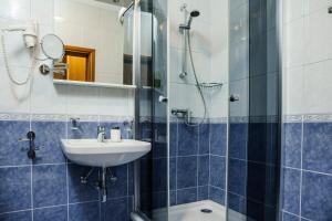 a bathroom with a sink and a shower at White Stone Villa in Promajna +42 photos