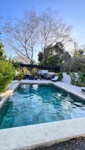 a swimming pool with blue water in a yard at GZ Suites in Coco