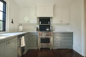 a kitchen with white cabinets and a stainless steel oven at Macons Historic Tatnall Home in Macon