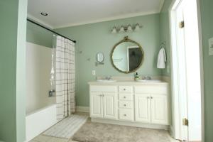 a bathroom with a white sink and a mirror at Macons Historic Tatnall Home in Macon