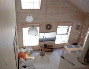 a living room with two windows and a couch at Koliwood B in Kolinkylä