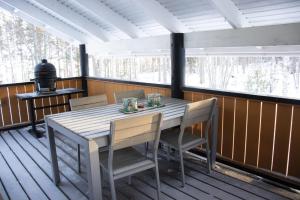 a table and chairs on a screened in porch at Koliwood B in Kolinkylä
