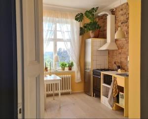 a kitchen with a sink and a stove top oven at Private floor in Molkom