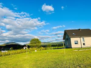 a soccer goal in a field next to a house at Polny Domek in Bystrzyca Kłodzka +55 photos
