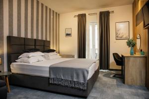 a hotel room with a bed and a chair at White Stone Villa 43 in Promajna