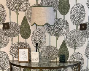 a room with a table with a wallpaper with trees at The Red Lion in Blewbury +30 photos