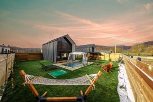 a backyard with a hammock and a house at Rubis Villa Bungalov in Elmalık