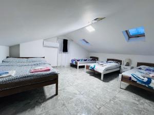 a bedroom with three beds in a room at Dardania Hostel in Peje