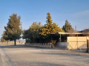 a parking lot with a fence and a canopy at Ebenezer Verblyf in Fraserburg