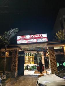 a man standing in front of a kang store at TANG HOSPITALITY Services in Gisenyi