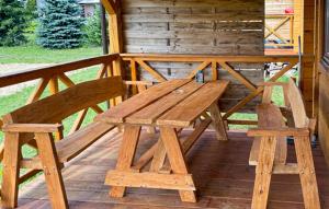 a wooden picnic table and two chairs on a deck at Amazing Home In Rybical With Wifi in Rybical
