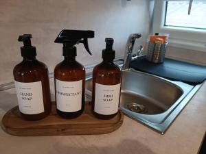 two bottles on a cutting board next to a sink at Max Mobile Home in Biograd na Moru +14 photos