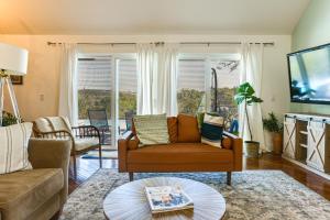 a living room with a couch and a tv at Infinity Edge Pool & Fire Pit: Spicewood Getaway! in Spicewood