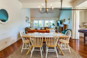 a dining room and living room with a table and chairs at Infinity Edge Pool & Fire Pit: Spicewood Getaway! in Spicewood