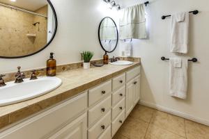 a bathroom with two sinks and a large mirror at Infinity Edge Pool & Fire Pit: Spicewood Getaway! in Spicewood +24 photos