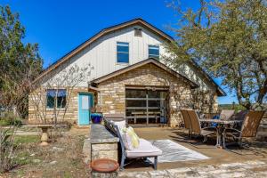 a stone house with a table and chairs in front of it at Infinity Edge Pool & Fire Pit: Spicewood Getaway! in Spicewood