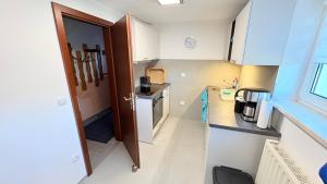 a small kitchen with white cabinets and a sink at Lutkistube in Lübben in Lübben