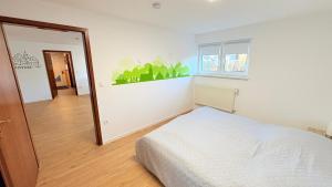 a bedroom with a bed and a large mirror at Lutkistube in Lübben in Lübben
