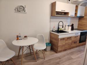 a kitchen with a table and chairs and a sink at Parc Central Republicii 63 in Baia Mare +18 photos
