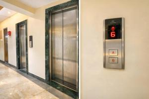 a row of elevators in an elevator in a building at Glitz Saineel Executive Near Juhu Beach in Mumbai