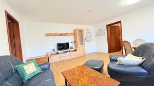 a living room with two couches and a tv at Lutkistube in Lübben in Lübben