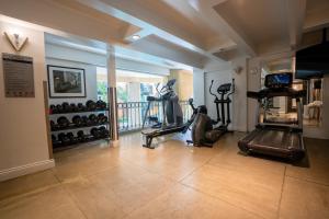 a gym with treadmills and exercise bikes in a room at Hôtel Plaza Québec par JARO in Quebec City