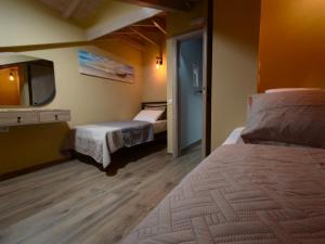a hotel room with two beds and a tv at Aria home in Tsoukalades