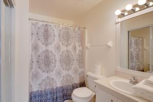 a bathroom with a toilet and a shower curtain at Steps from Crystal River: Crystal River Getaway! in Crystal River +16 photos
