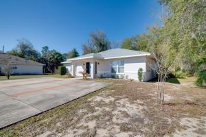 a small white house with a driveway at Steps from Crystal River: Crystal River Getaway! in Crystal River