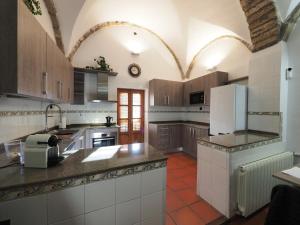 a kitchen with wooden cabinets and a white refrigerator at Casa Ara in Boltaña