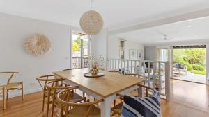 a dining room with a wooden table and chairs at Waves on Rye in Rye