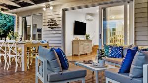 a living room with a couch and a table at Waves on Rye in Rye
