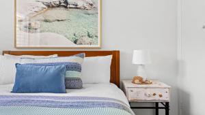 a bedroom with a bed and a picture on the wall at Waves on Rye in Rye