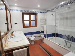 a bathroom with a sink and a shower and a toilet at Casa Ara in Boltaña +12 photos