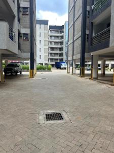 a parking lot with a grate in the middle of a building at JOJO Staycations in Rungiri