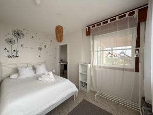 a bedroom with a white bed and a window at Casa Ángel 1982 in Oia