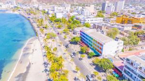 an aerial view of a beach and buildings at Panamerican Hostel in Santa Marta
