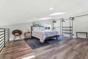 a bedroom with a bed and a wooden floor at Angie Oasis Yard, Loft & Stocked Kitchen in San Ramon