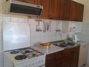 a kitchen with a white stove and a sink at Apartment Dora in Splitska +15 photos