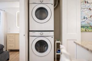 two washing machines are stacked in a living room at Luxury Downtown 2 Bedroom Flat in Neenah +7 photos