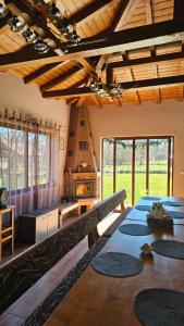 a living room with a table and a fireplace at Къща за гости Ореха in Apriltsi +121 photos