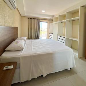 a bedroom with a large white bed in a room at Hotel Vale da Serra in Parauapebas +162 photos